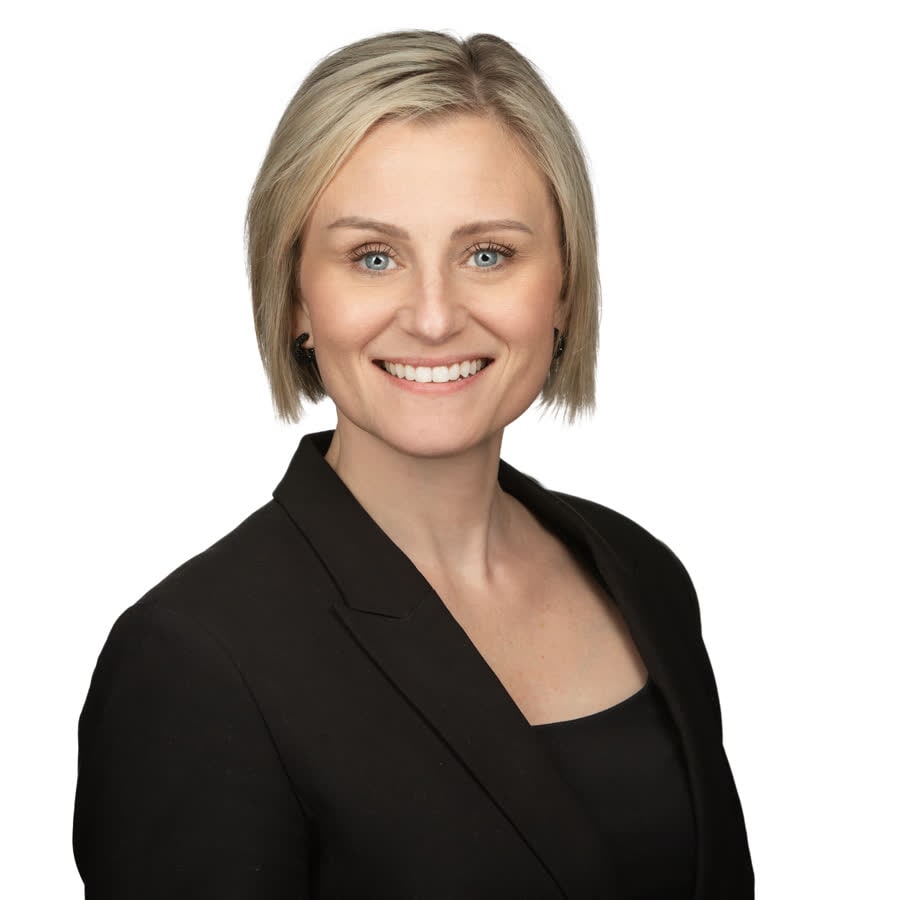 Professional corporate headshot of a man in a suit jacket